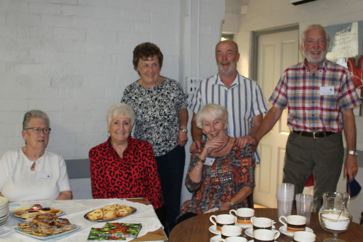 The team serving coffee and cakes